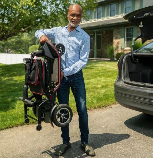 Ultra-light scooter folded for transport, carried by hand